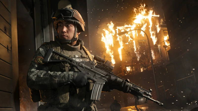 Ein bewaffneter Soldat vor einem brennenden Gebäude in Modern Warfare 4