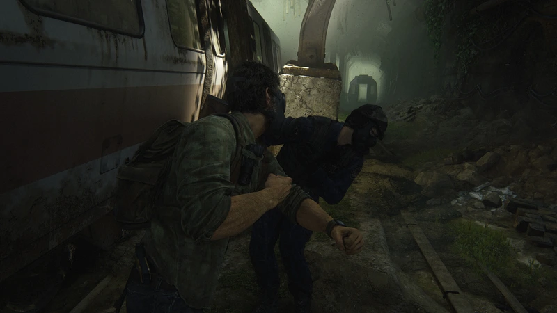 Joel grapples with a masked attacker beside a train in The Last of Us Part I