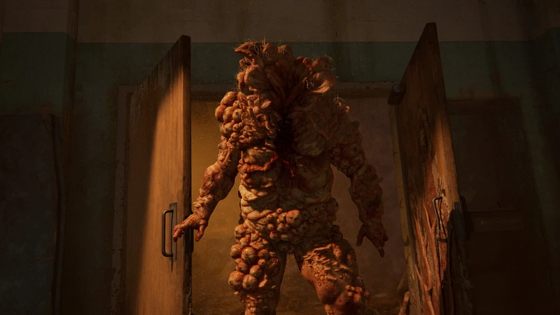 A bloater stands in a doorway in The Last of Us Part I