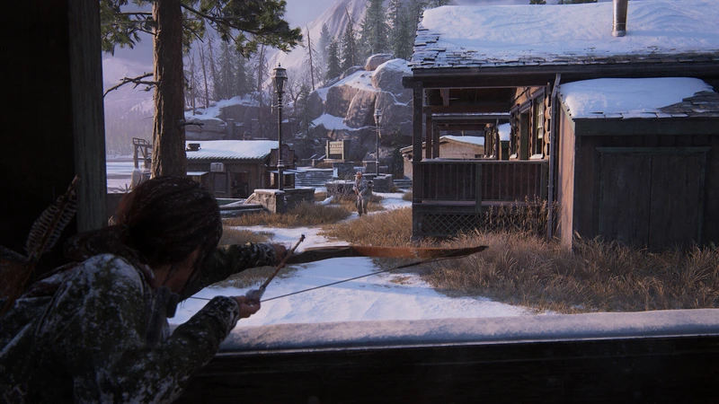 Ellie aims a bow in a snowy settlement in The Last of Us Part I