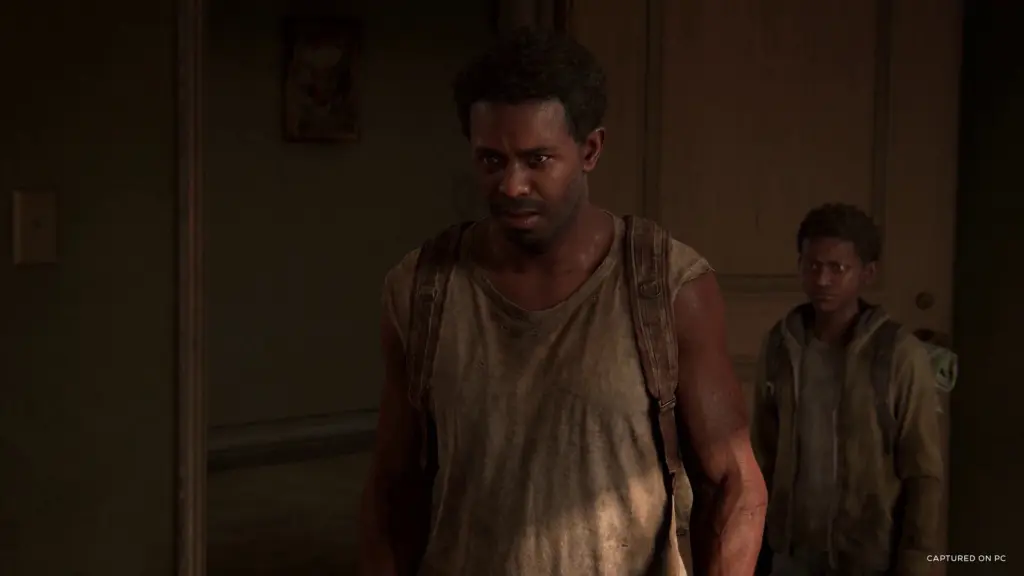Henry and Sam indoors in The Last of Us Part I