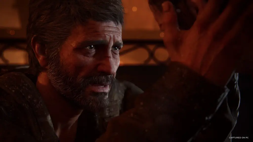 A close-up of Joel in warm lighting in The Last of Us Part I