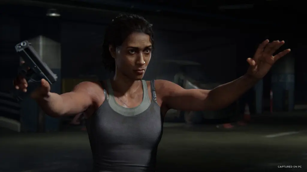 Marlene holds a pistol with her other hand raised in The Last of Us Part I