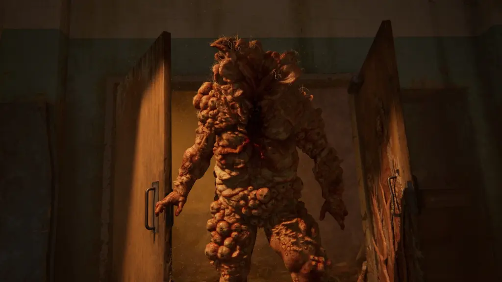 A bloater stands in a doorway in The Last of Us Part I