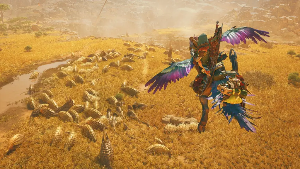 Monster Hunter Wilds: Охотник верхом над стадом монстров в золотистом поле